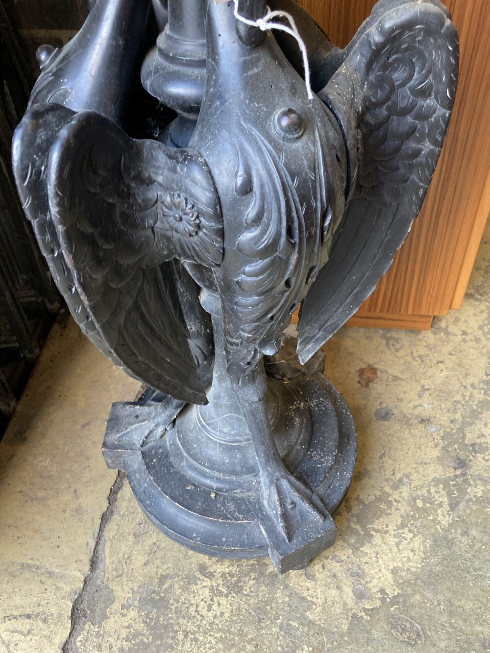 A Victorian ebonised carved wood lamp table in the form of three monopodiae stylised birds, 38cm diameter, height 94cm